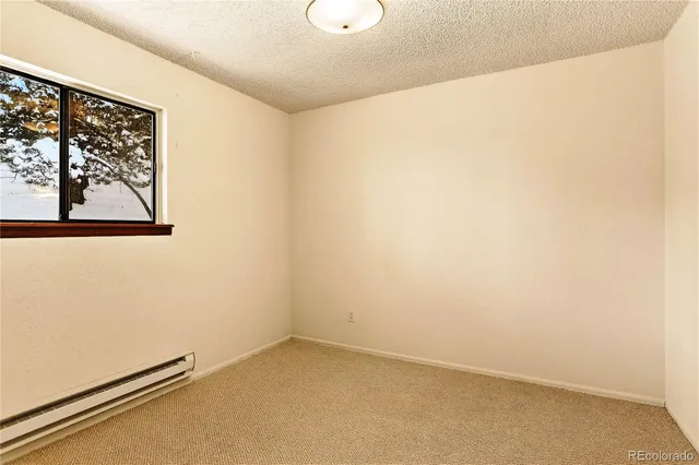 a bedroom with a bed and a night stand