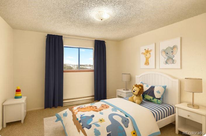 217 Catamount Ridge Road Bailey, CO 80421 - Photo 20 of 37 a bedroom with a bed and a couch