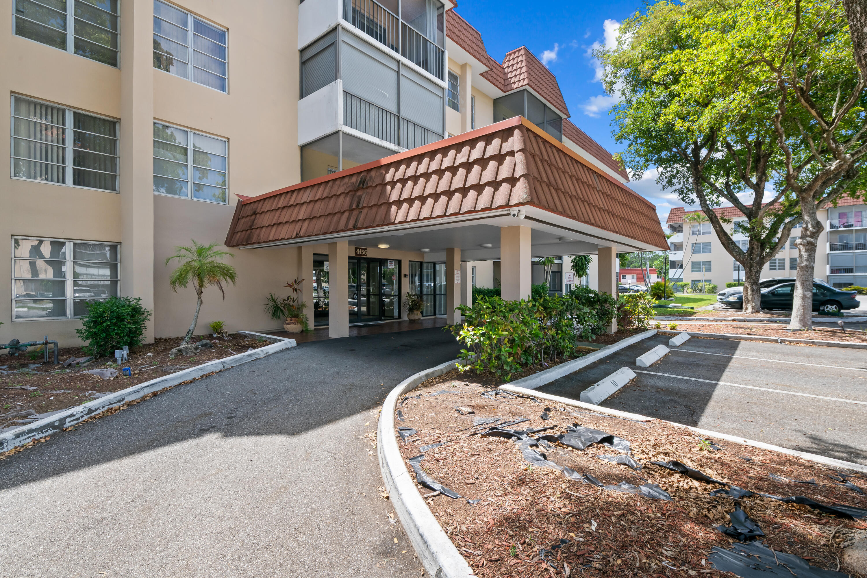 4156 Inverrary Drive, Unit 210 Lauderhill, FL 33319 - Photo 27 of 27 a view of a white building among the street with palm trees