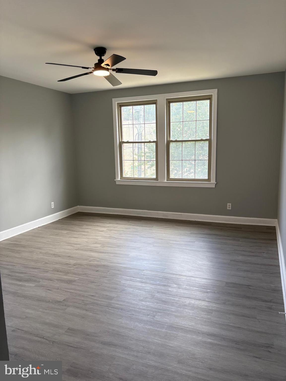 6722 3rd Street Northwest, Unit 204 Washington, DC 20012 - Photo 12 of 23 an empty room with wooden floor and windows