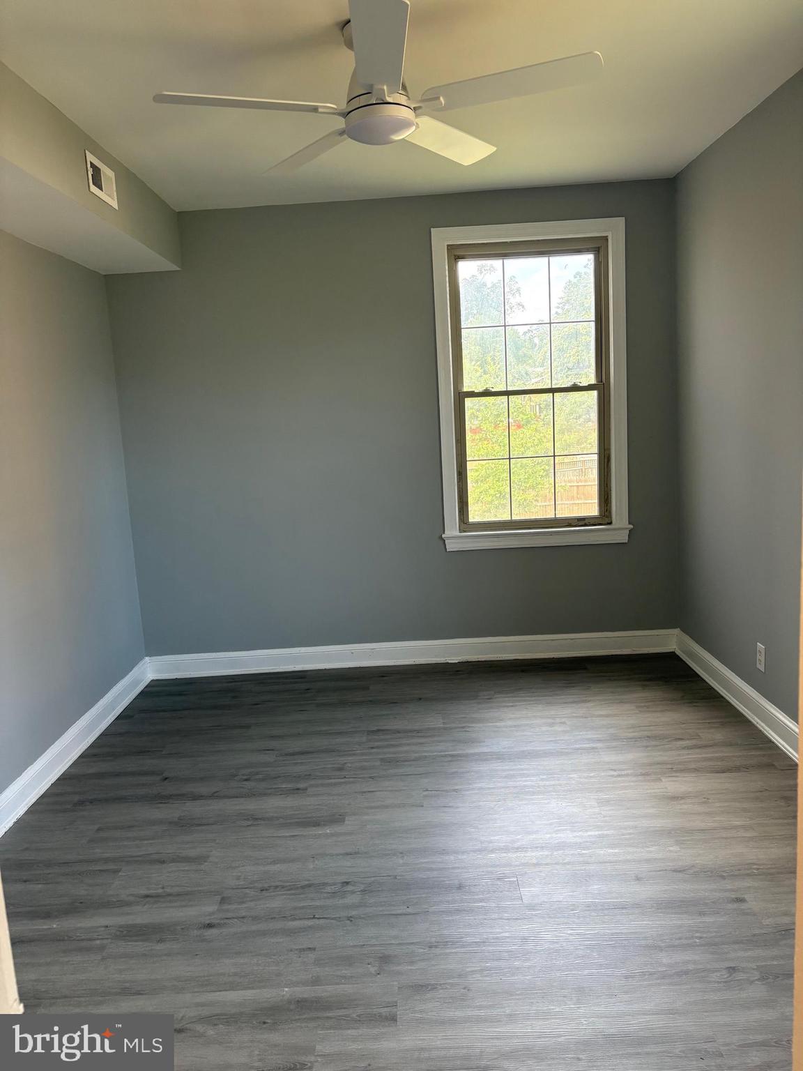 6722 3rd Street Northwest, Unit 204 Washington, DC 20012 - Photo 9 of 23 an empty room with wooden floor and windows