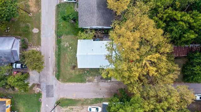 an aerial view of a house with a yard