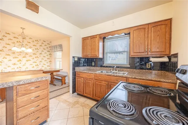 a kitchen with stainless steel appliances granite countertop a sink stove and cabinets