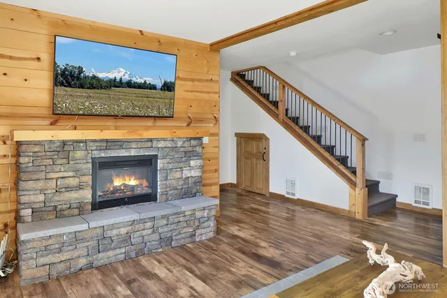 a living room with furniture a flat screen tv and a fireplace