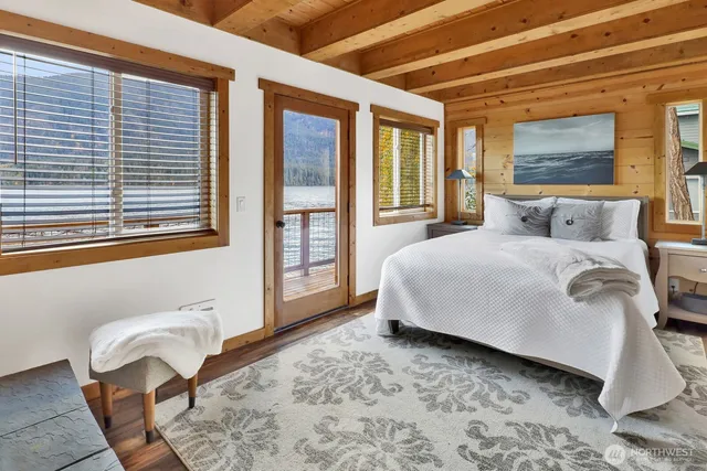 a bedroom with a bed chair and window