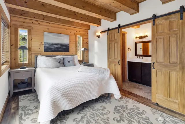 a bedroom with a bed and a refrigerator