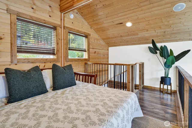 a bedroom with furniture and a large window