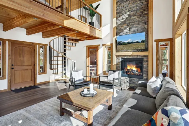 a living room with furniture fireplace and wooden floor