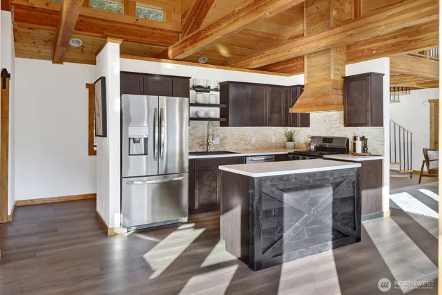 a kitchen with stainless steel appliances a refrigerator and a stove