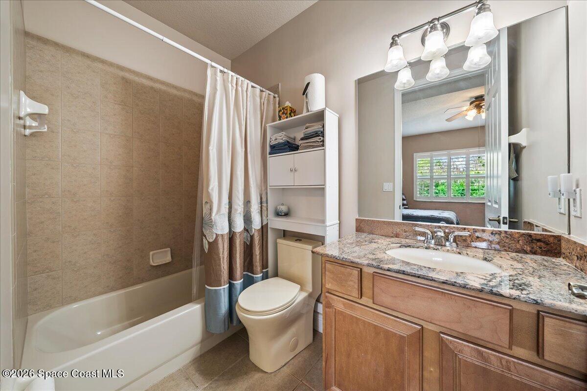6005 Highway 1, Unit 101 Rockledge, FL 32955 - Photo 30 of 57 a bathroom with a granite countertop sink toilet and shower