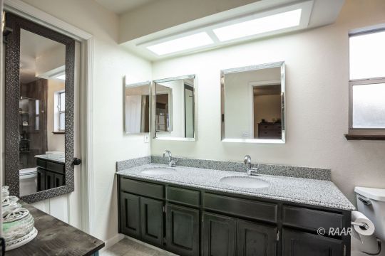 532 Amanda Street Ridgecrest, CA 93555 - Photo 18 of 35 a bathroom with a granite countertop sink and a mirror