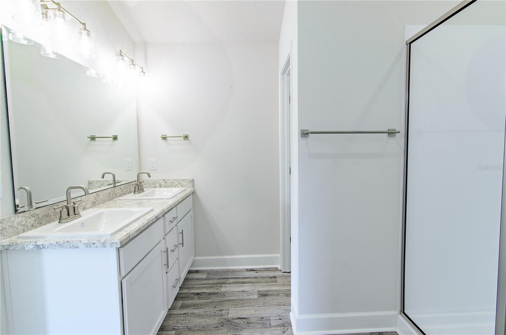 30 Priory Lane Palm Coast, FL 32164 - Photo 17 of 31 a spacious bathroom with a double vanity sink and a mirror