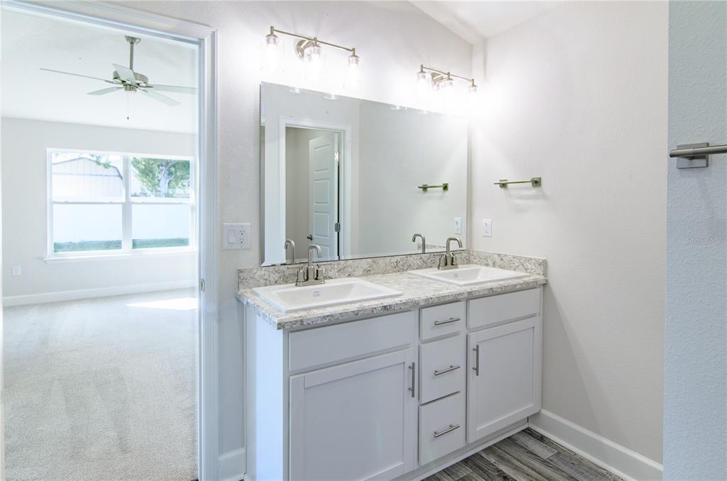 30 Priory Lane Palm Coast, FL 32164 - Photo 18 of 31 a bathroom with a granite countertop sink and a mirror