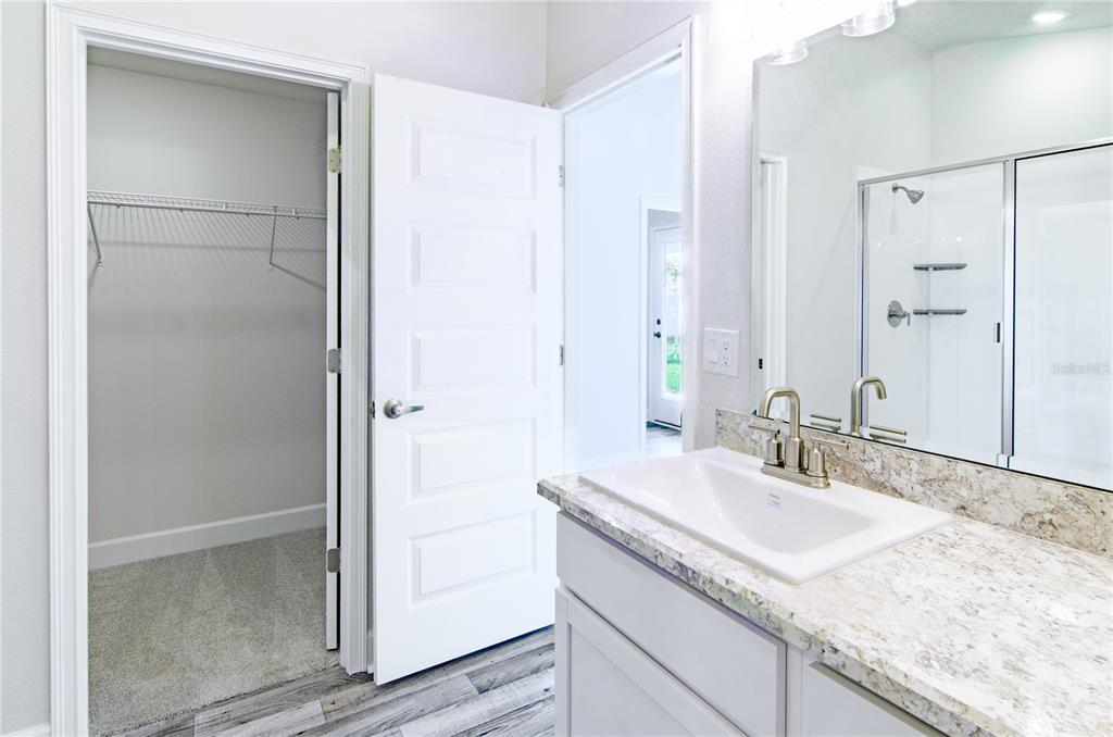 30 Priory Lane Palm Coast, FL 32164 - Photo 19 of 31 a bathroom with a granite countertop sink and a mirror