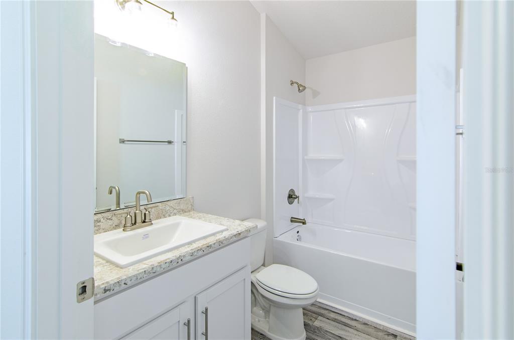 30 Priory Lane Palm Coast, FL 32164 - Photo 23 of 31 a bathroom with a sink toilet a bathtub and shower