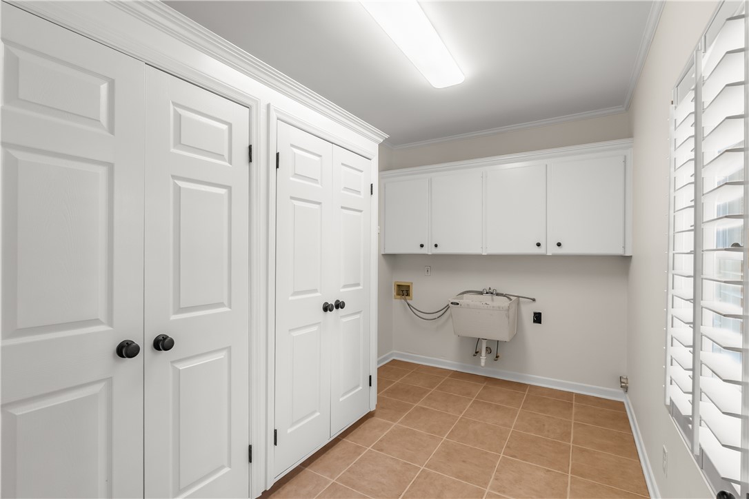 312 English Oak Road Simpsonville, SC 29681 - Photo 11 of 48 This functional laundry area features ample storage and a convenient utility sink.