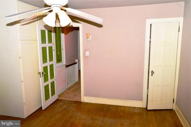 a view of a room with a window and wooden floor