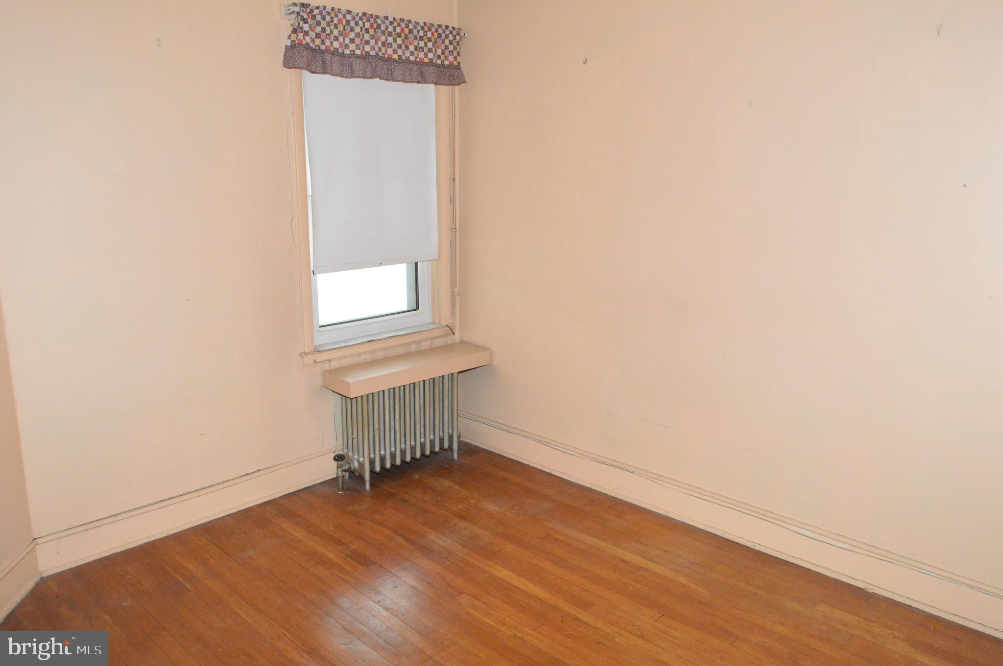 304 North 25th Street Reading, PA 19606 - Photo 16 of 31 a view of an empty room with wooden floor and a window