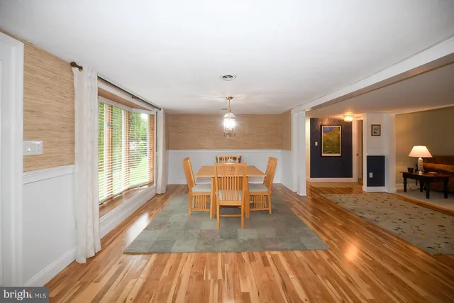 a dining room with furniture and wooden floor