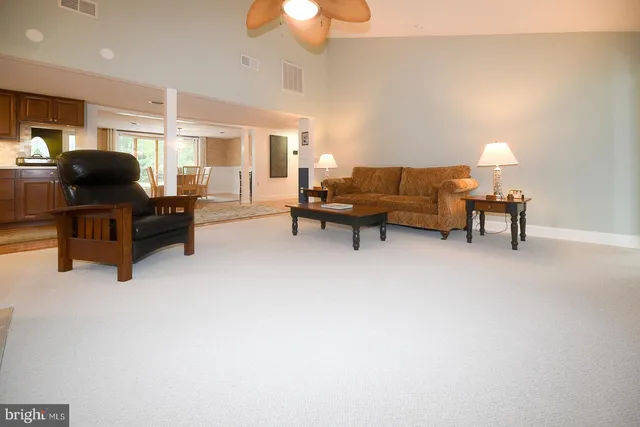 a living room with furniture and a lamp