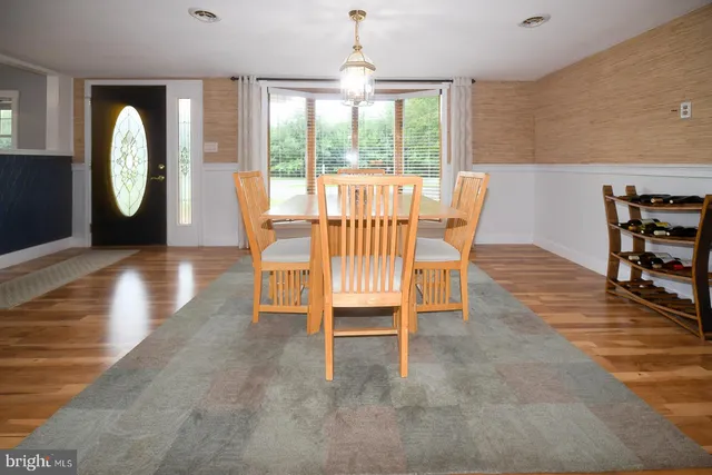 a view of a livingroom with wooden floor and window
