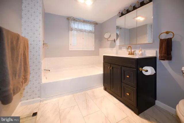 a en suite bathroom with a sink and window