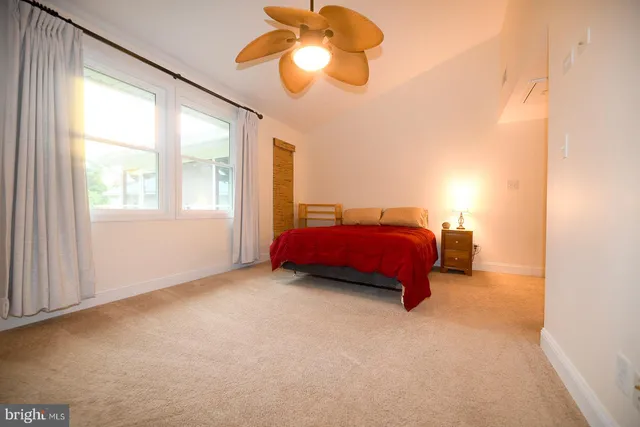 a living room with furniture tv and a large window