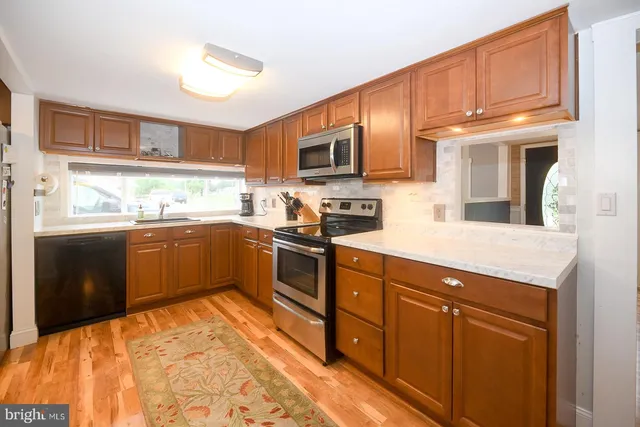a kitchen with stainless steel appliances granite countertop a sink and cabinets