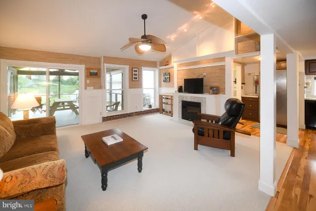 a living room with furniture fireplace and flat screen tv
