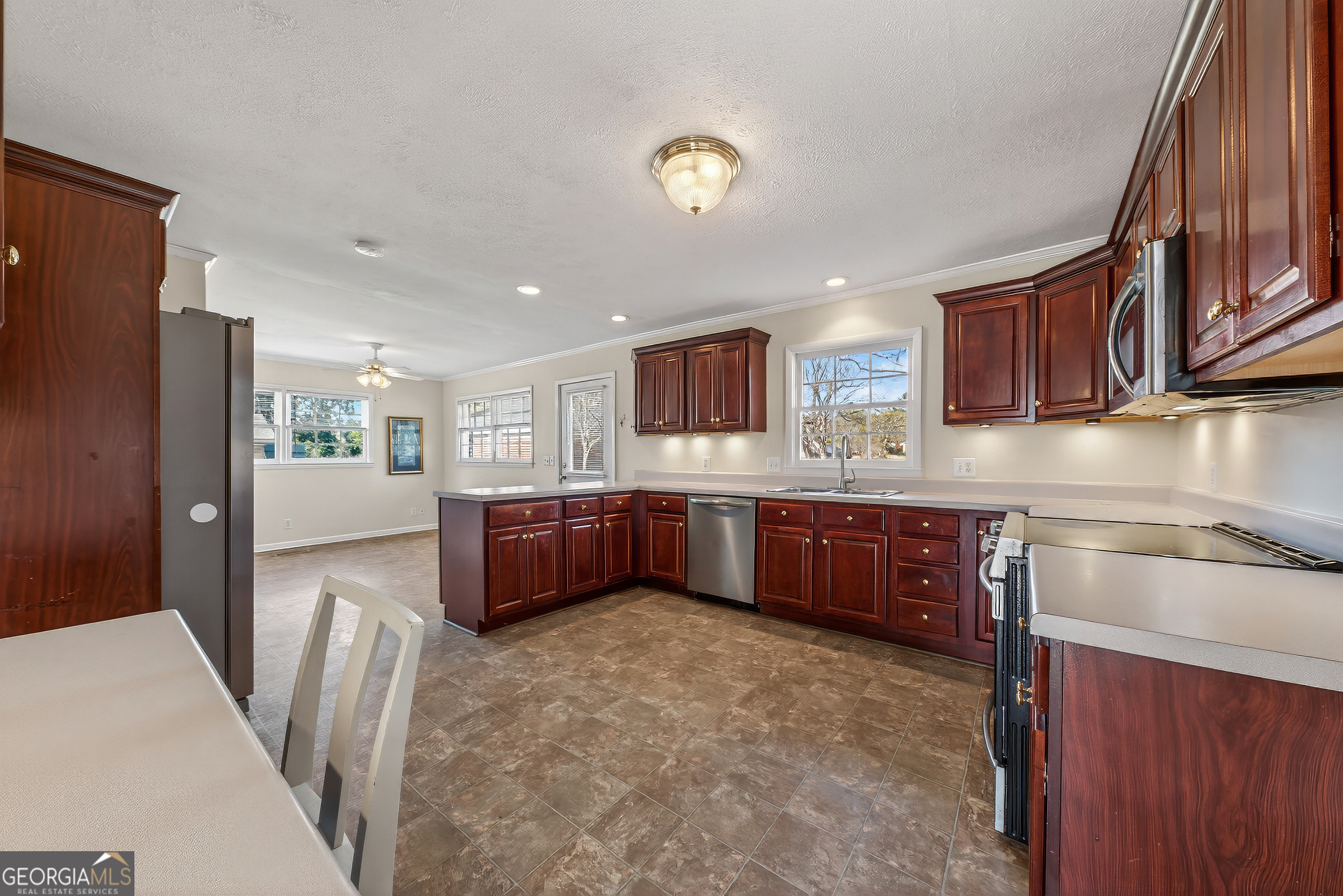 741 East Avenue Madison, GA 30650 - Photo 14 of 40 a kitchen with stainless steel appliances granite countertop a refrigerator a stove a sink a microwave a refrigerator and cabinets
