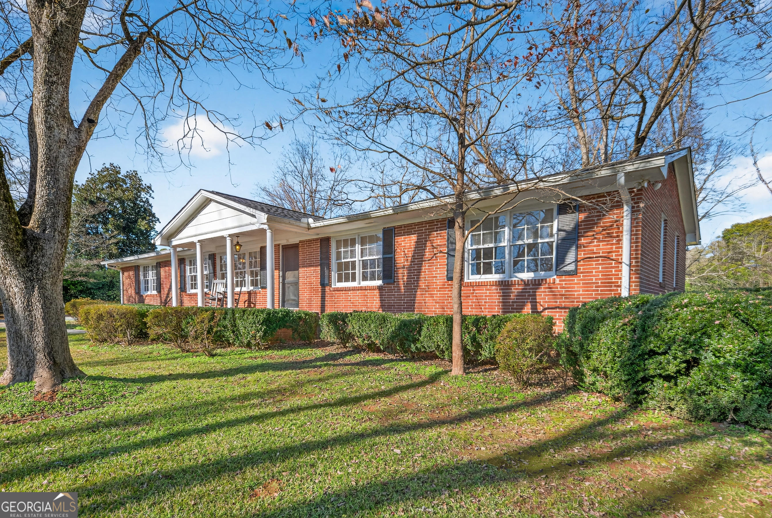 741 East Avenue Madison, GA 30650 - Photo 2 of 40 a front view of a house with a yard