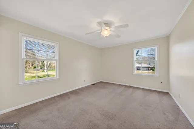 a view of an empty room with a ceiling fan