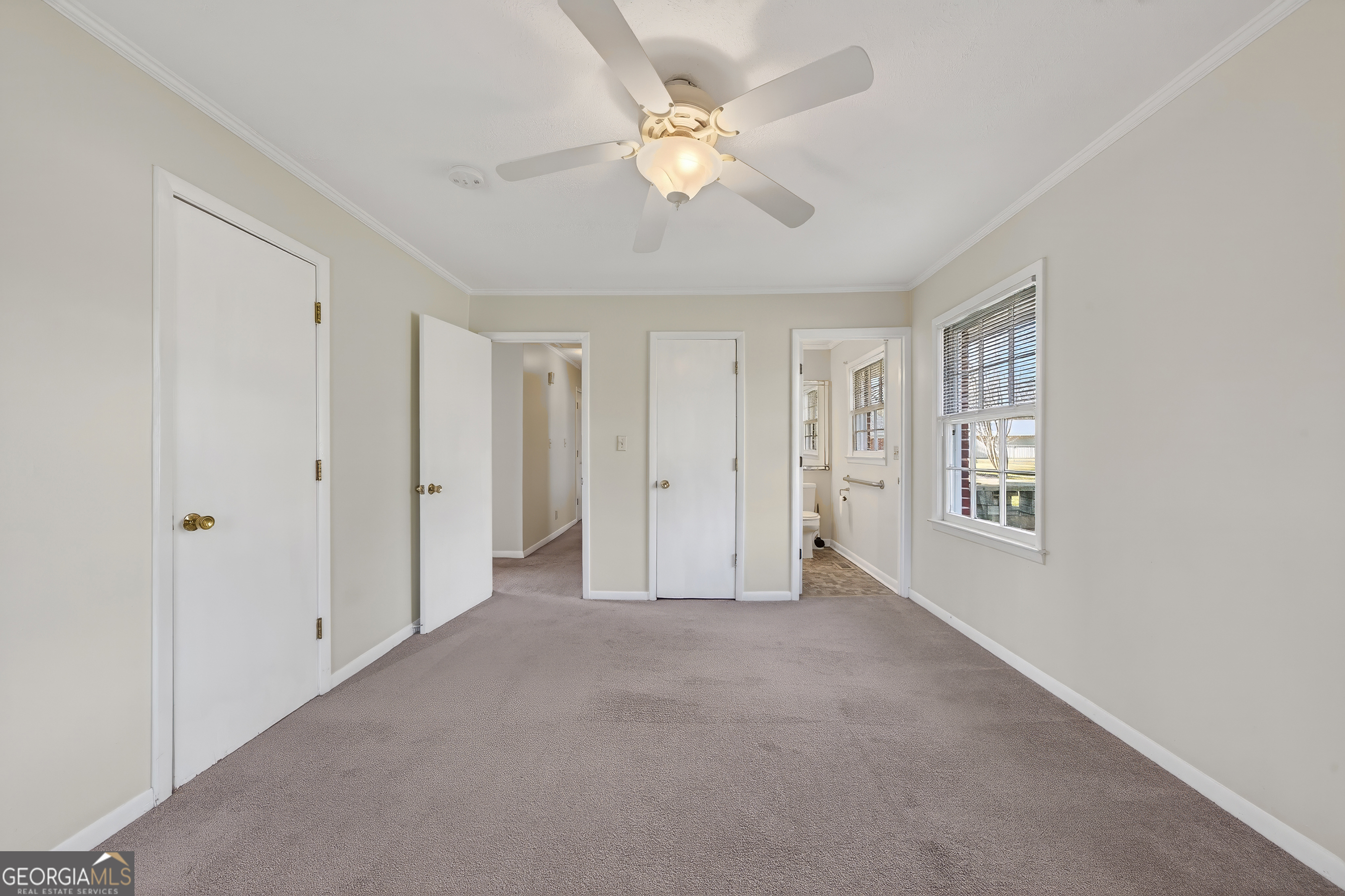 741 East Avenue Madison, GA 30650 - Photo 22 of 40 a view of an empty room with a ceiling fan