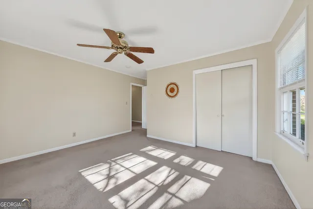 a view of room with a ceiling fan and window