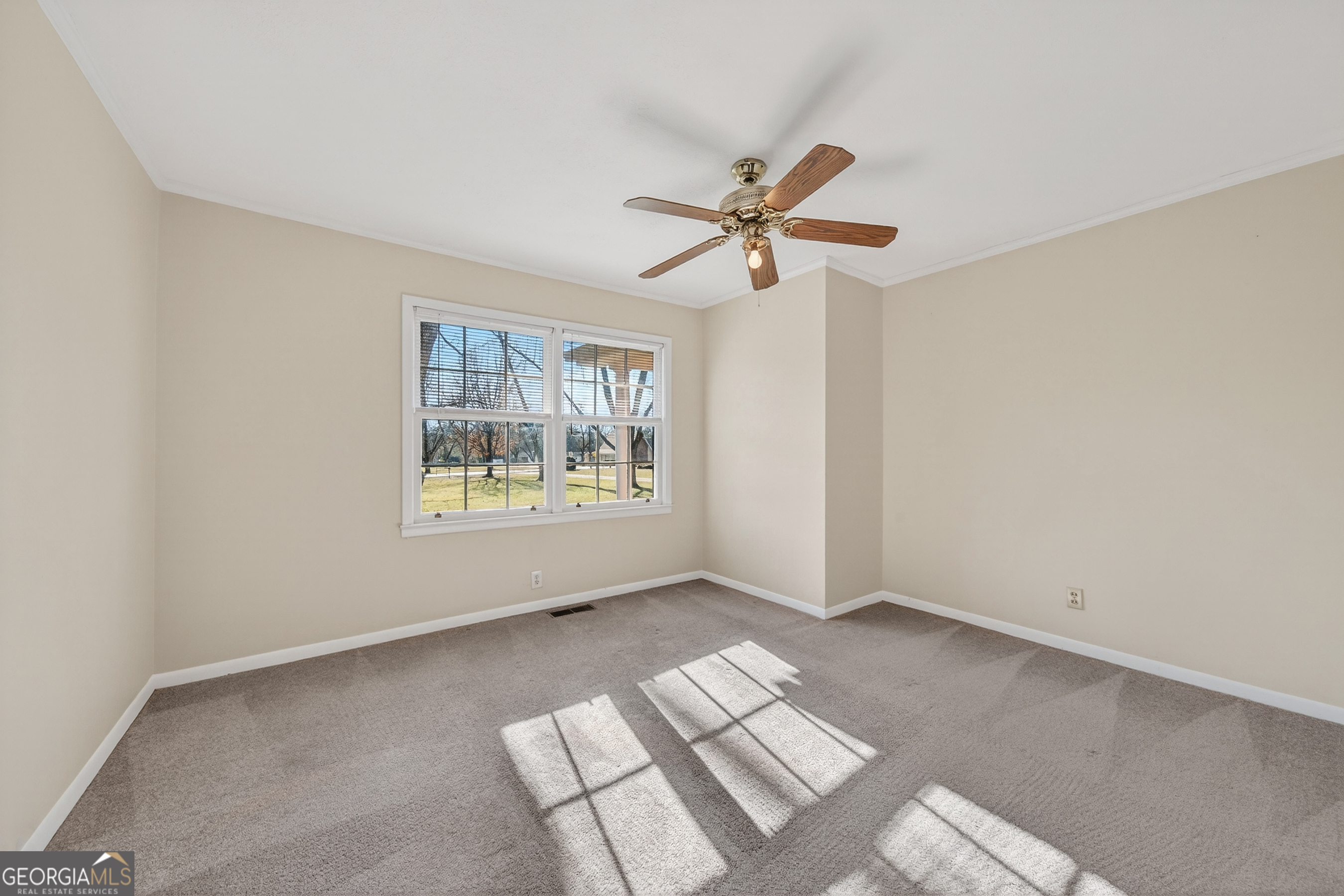 741 East Avenue Madison, GA 30650 - Photo 26 of 40 a view of room with a ceiling fan and window