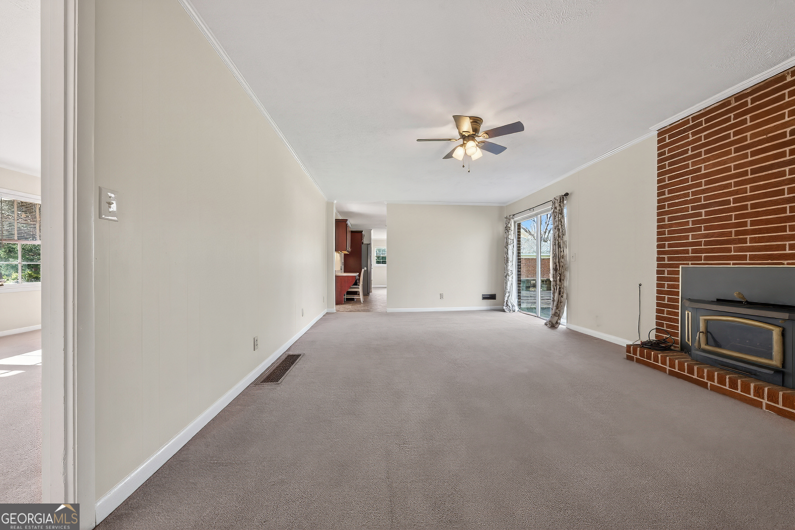 741 East Avenue Madison, GA 30650 - Photo 28 of 40 a view of a livingroom with a ceiling fan and window