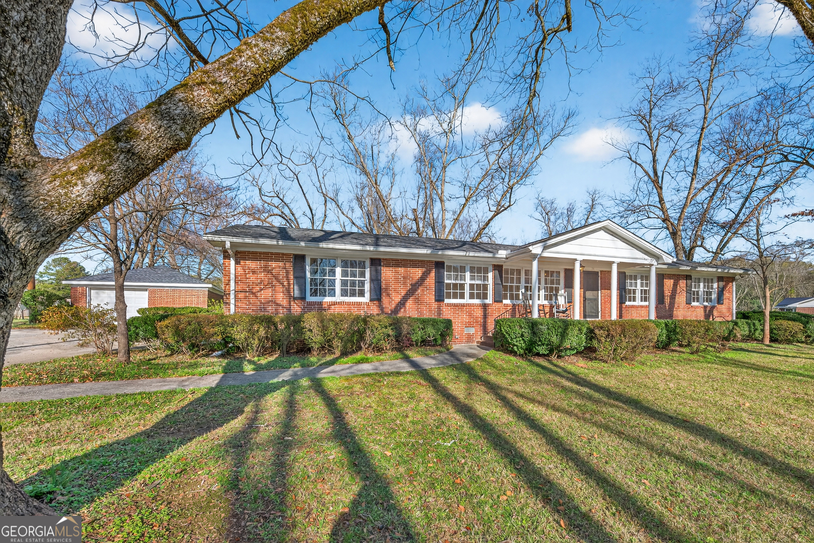 741 East Avenue Madison, GA 30650 - Photo 3 of 40 a front view of a house with a yard