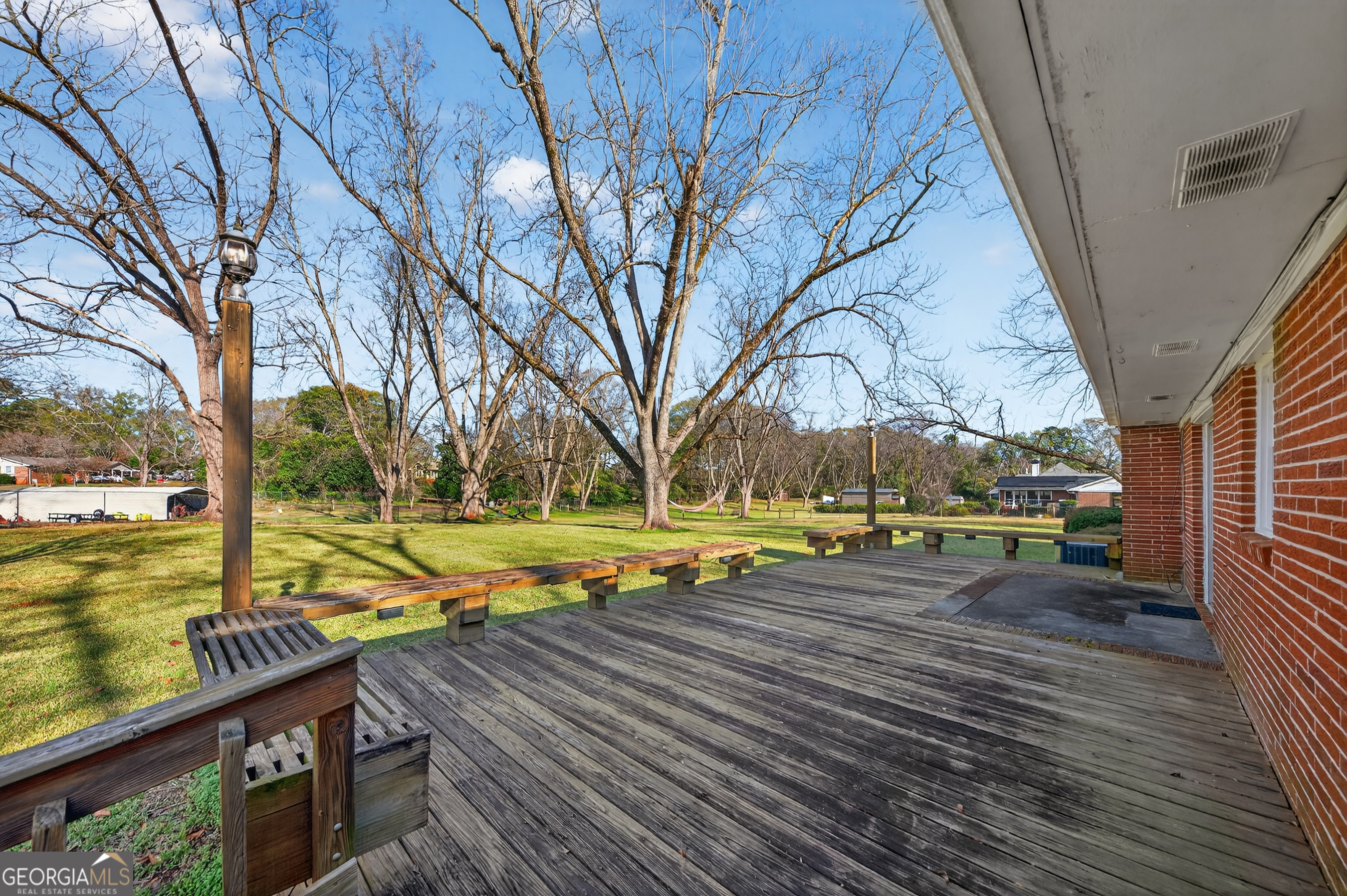 741 East Avenue Madison, GA 30650 - Photo 32 of 40 a view of a yard with wooden deck