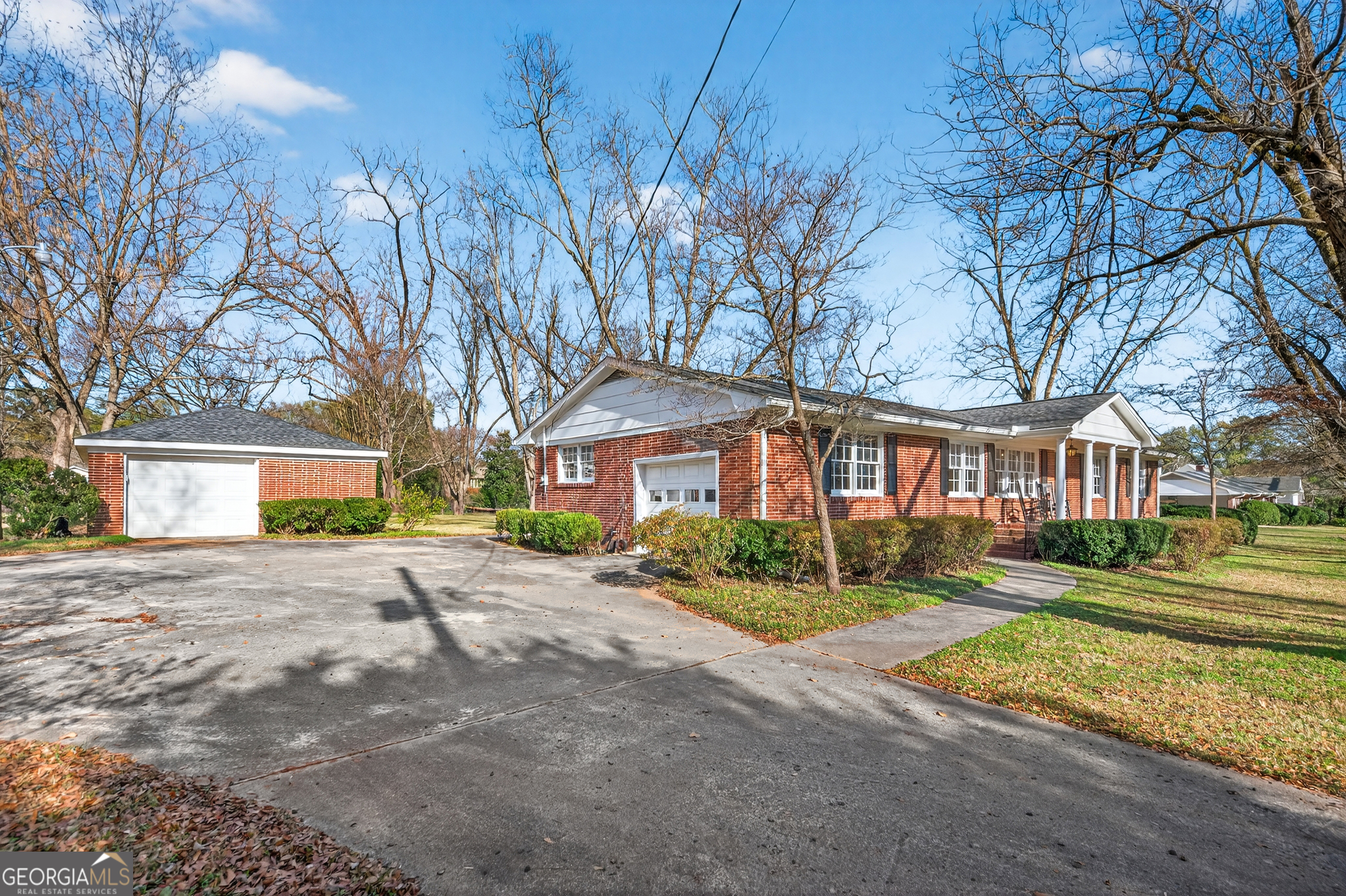 741 East Avenue Madison, GA 30650 - Photo 4 of 40 a view of a big house with a big yard and large trees