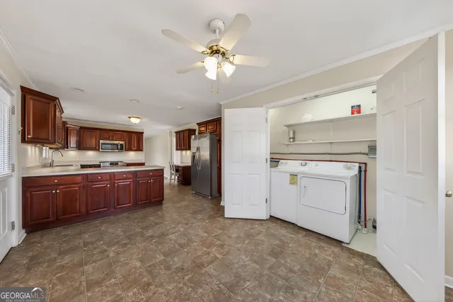 a kitchen with a stove a sink and a refrigerator