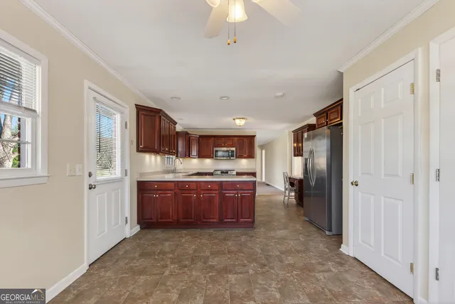 a large kitchen with a stove and refrigerator
