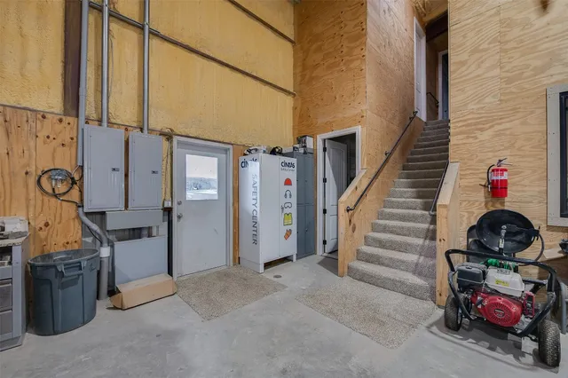 a kitchen with a stove a table and chairs in it