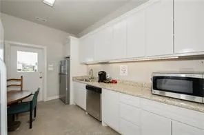 a kitchen with sink cabinets and microwave