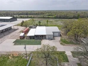 an aerial view of a house with a yard and lake view