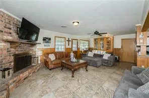 a living room with furniture fireplace and flat screen tv