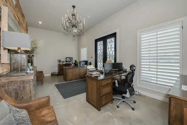 a view of a livingroom with workspace and a window