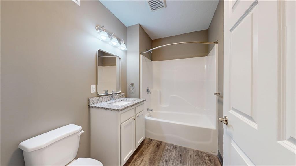1450 Fifth Avenue, Unit 300 Pittsburgh, PA 15219 - Photo 12 of 24 a bathroom with a granite countertop sink toilet and shower