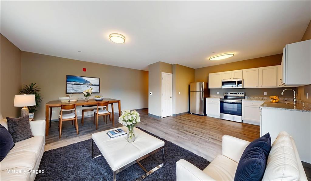 1450 Fifth Avenue, Unit 300 Pittsburgh, PA 15219 - Photo 22 of 24 a living room with furniture and a kitchen