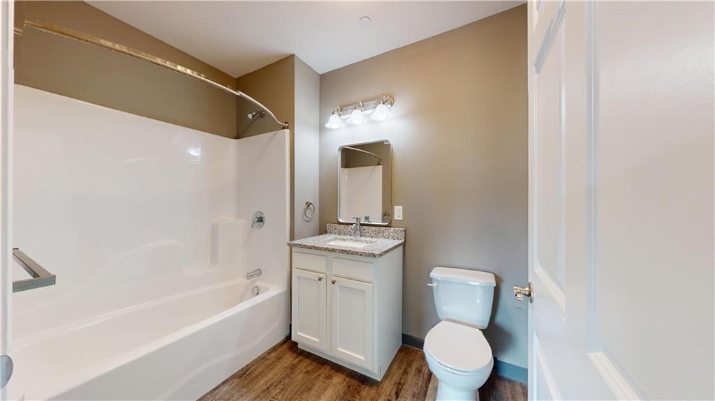 1450 Fifth Avenue, Unit 300 Pittsburgh, PA 15219 - Photo 8 of 24 a bathroom with a toilet sink and mirror