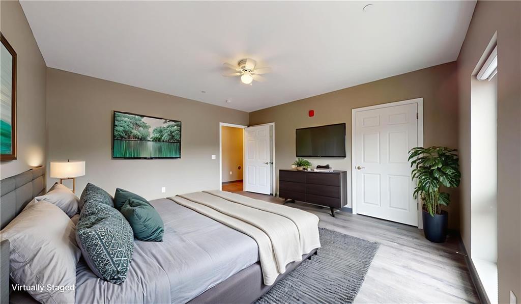 1450 Fifth Avenue, Unit 300 Pittsburgh, PA 15219 - Photo 10 of 24 a bedroom with a bed and a flat screen tv